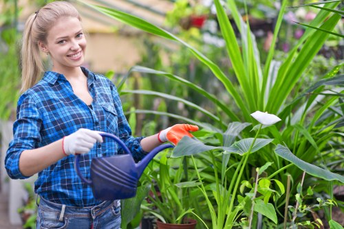 Staff member setting up secure payment terminal for gardening services